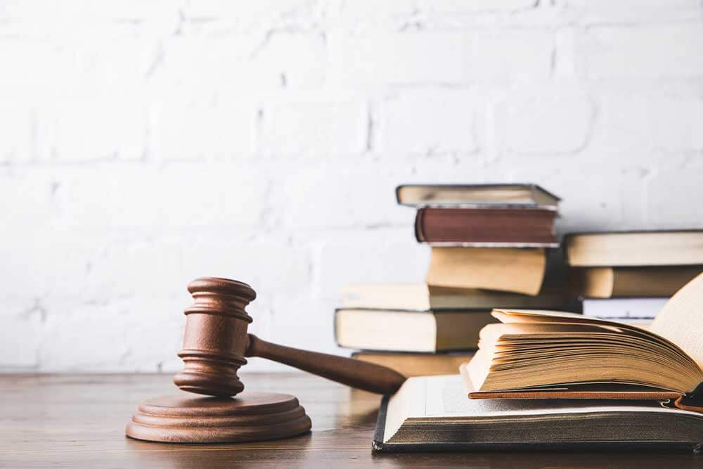 A judge's gavel and law books on a table.