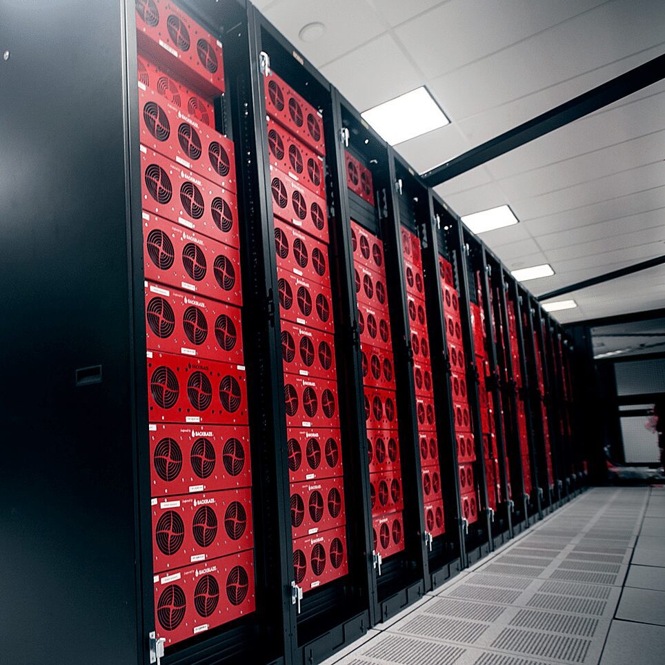 A row of red servers in a data center providing website hosting.