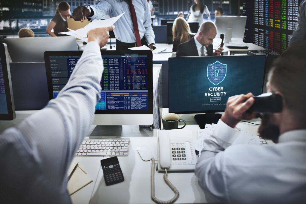 A group of people using computers in an office.