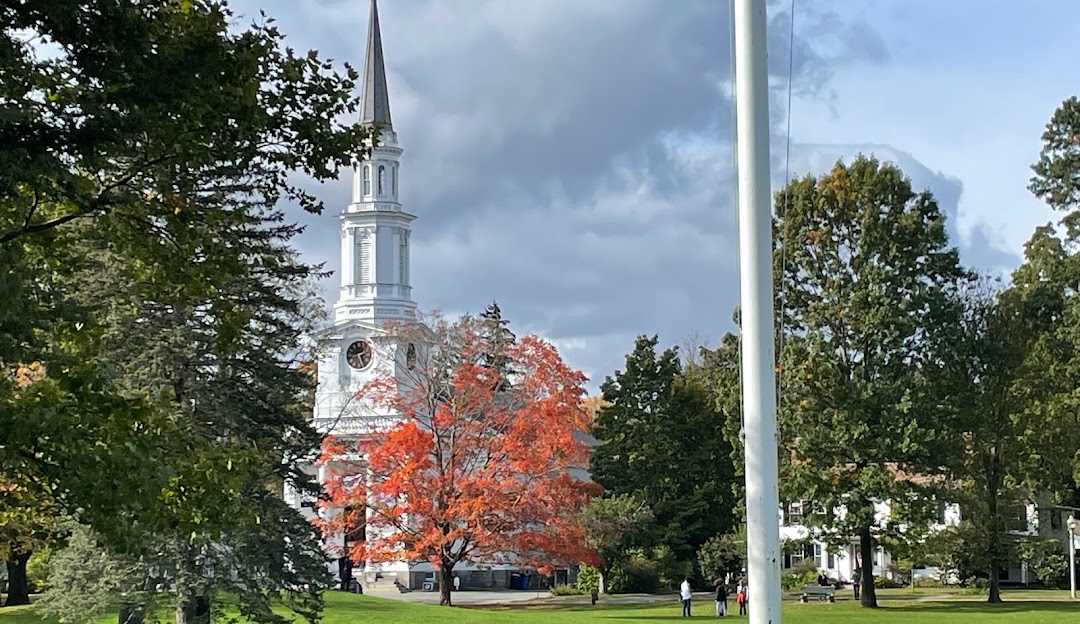 A white church with a steeple in the background. A white church with a steeple in the background.