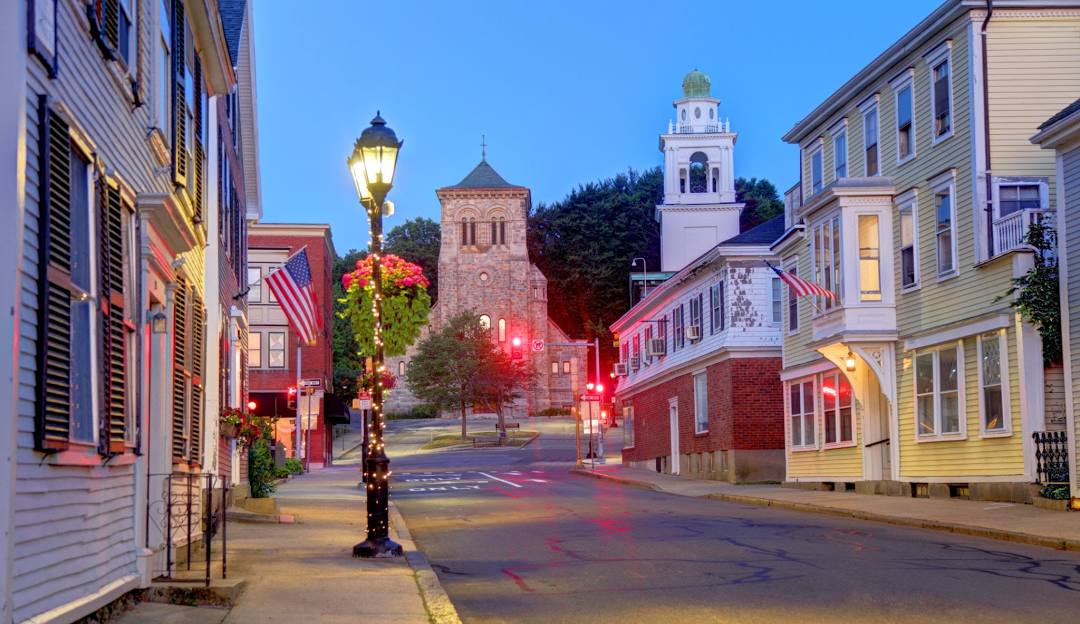 A street lined with buildings and a clock tower in Plymouth. A street lined with buildings and a clock tower in Plymouth.