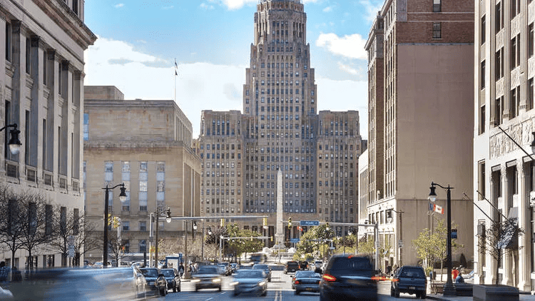 A city street with a tall building in New York.