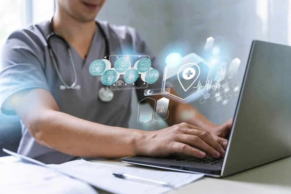 A healthcare professional using a laptop with floating medical icons seamlessly integrates advanced healthcare IT solutions into their workflow.