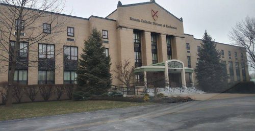 Exterior view of a modern educational building with a cross symbol, indicating a religious affiliation, possibly a catholic institution, and managed IT services in Ogden.